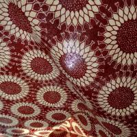 Tissu coton wax bordeaux motif fleurs soleil
