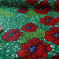 Tissu wax beaux pavots sur fond vert prairie